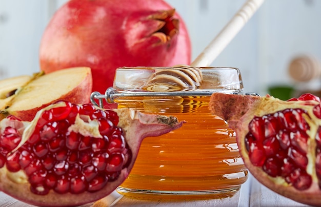 Premium Photo | Rosh hashanah -traditional symbols: honey jar and fresh ...