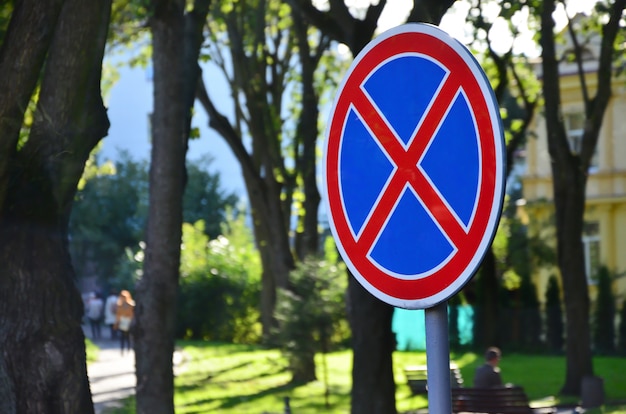 Premium Photo | Round road sign with a red cross on a blue background ...