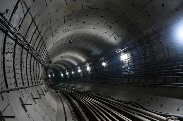 Premium Photo | Round underground winding subway tunnel going into the ...