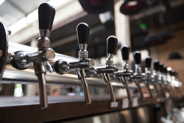 Free Photo | Row of beer taps in pub