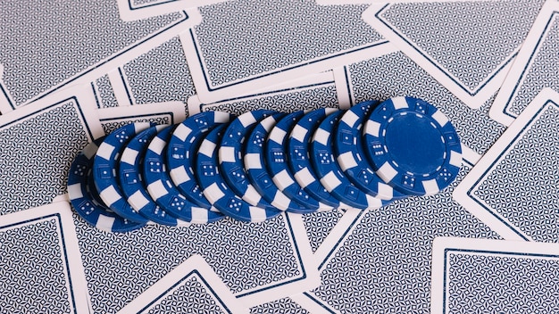 Premium Photo | Row of blue poker chips on playing cards