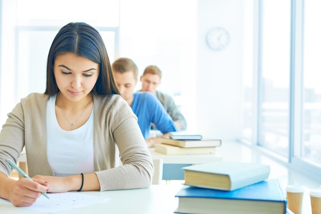 Row of students doing an exam Free Photo