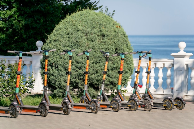 Premium Photo | A Row Of Parked Scooters On The City Sidewalk, Electric ...