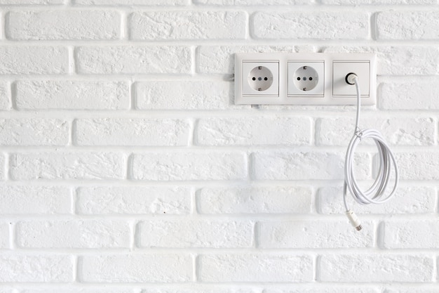 Premium Photo Row Of Power And Tv Sockets And Tv Cable On Brick Wall