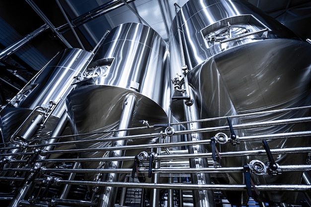 Premium Photo | Rows of steel tanks for beer fermentation and ...