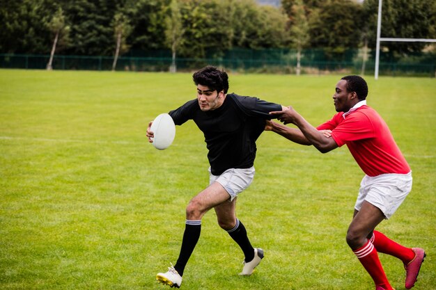 premium-photo-rugby-players-tackling-during-game