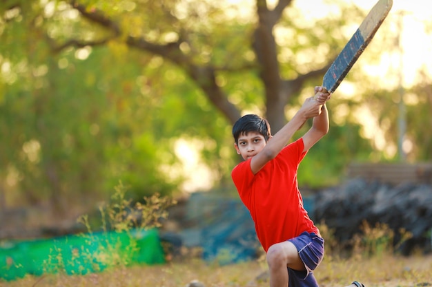 Premium Photo | Rural indian child playing cricket