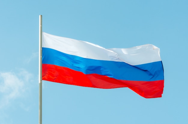 Premium Photo | Russia flag. waving colorful russia flag on blue sky.