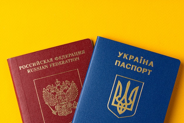 Premium Photo | Russian and ukrainian passport together on yellow