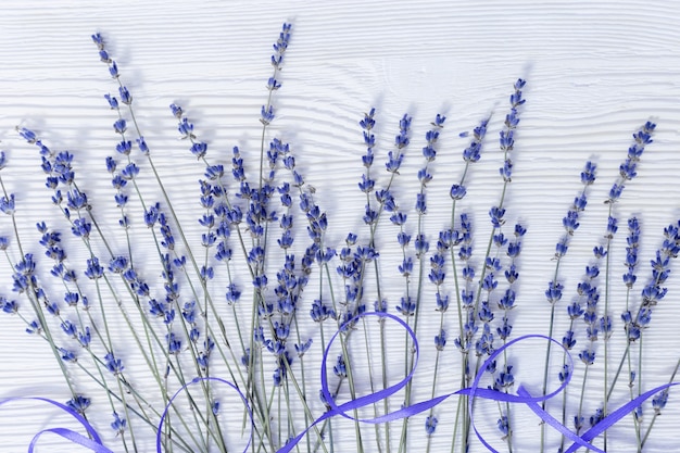 Rustic background with lavender flowers on white wooden surface. selective focus. Premium Photo