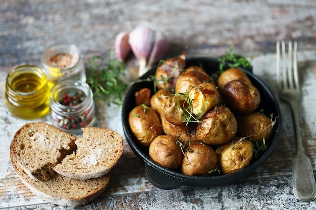 Premium Photo | Rustic potato in a pan. baked small potatoes in a peel ...