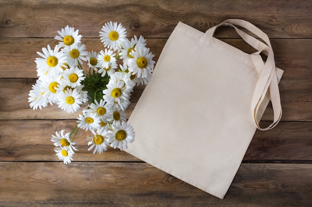 Download Premium Photo | Rustic tote bag mockup with daisy