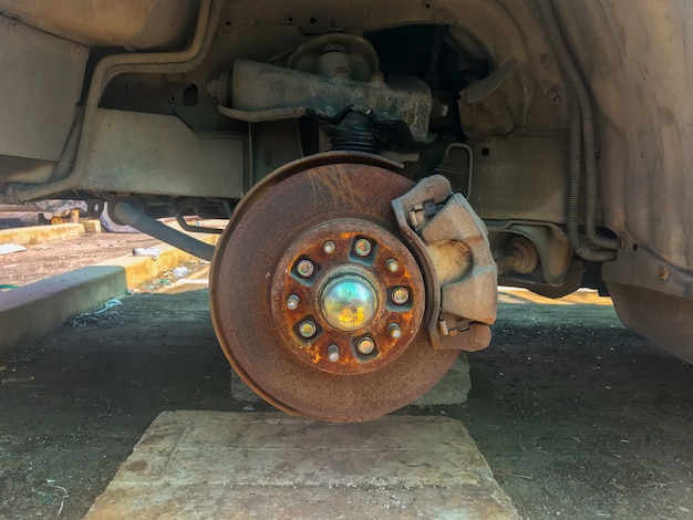 Premium Photo | Rusty broken car with missing wheel