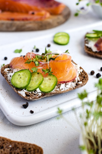 Premium Photo | Rye bread, smoked salmon, cucumber and microgreens