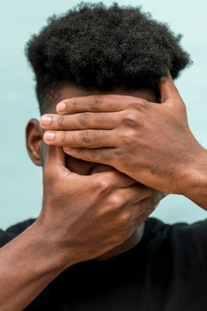 Free Photo | Sad black man with hands covering face