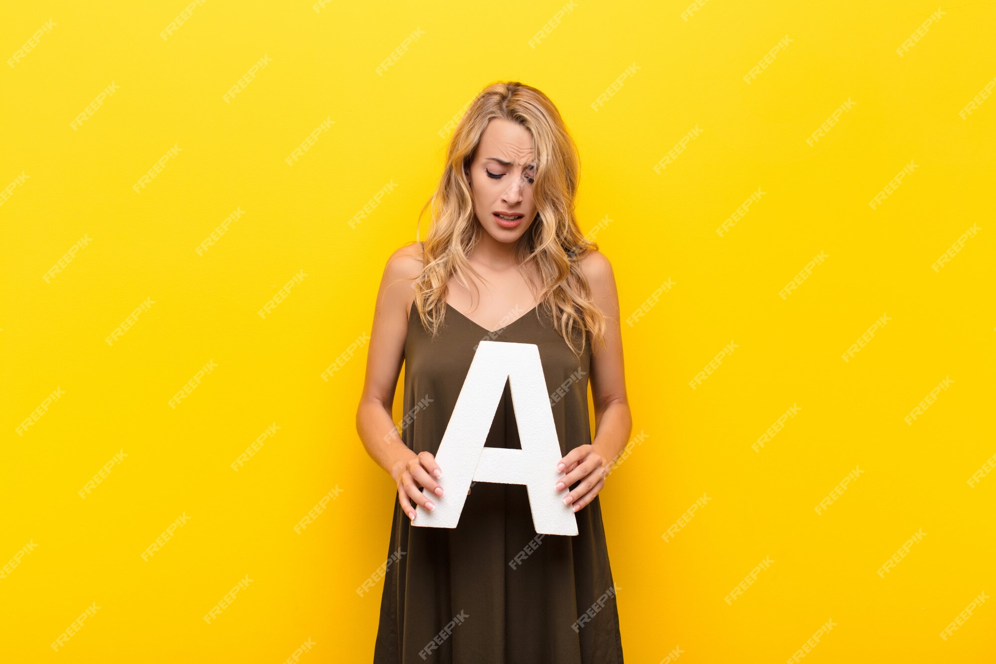 premium-photo-sad-depressed-unhappy-holding-the-letter-a-of-the