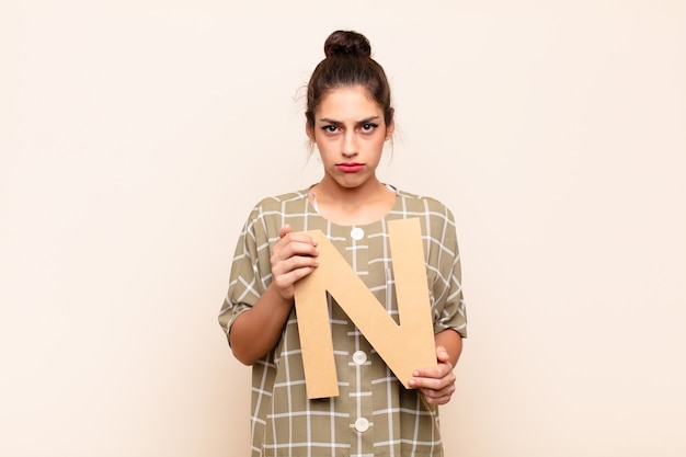 premium-photo-sad-depressed-unhappy-holding-the-letter-n-of-the