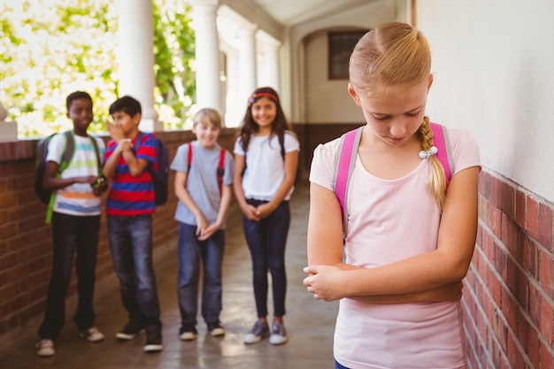 Premium Photo | Sad schoolgirl with friends in background at school ...