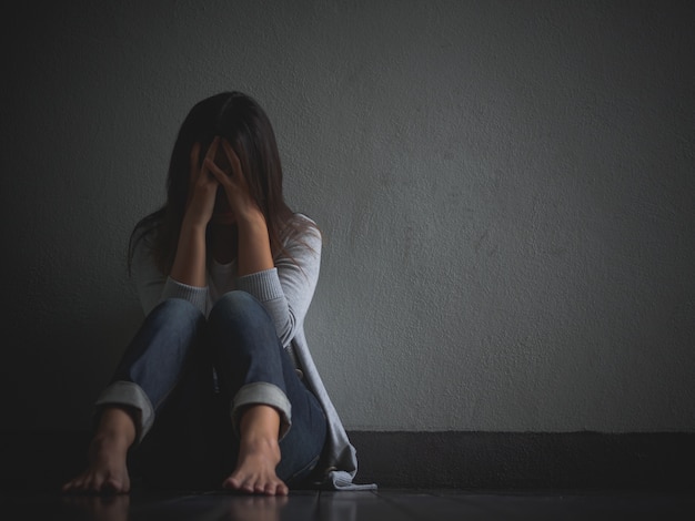 Sad Woman Hug Her Knee And Cry Sitting Alone In A Empty Room Photo Premium Download