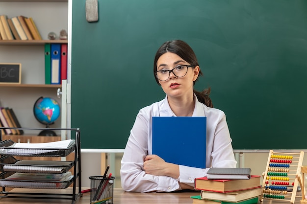 Учитель более. Грустный учитель. Учительница за столом без лица. Teacher Glasses. Teacher Table.