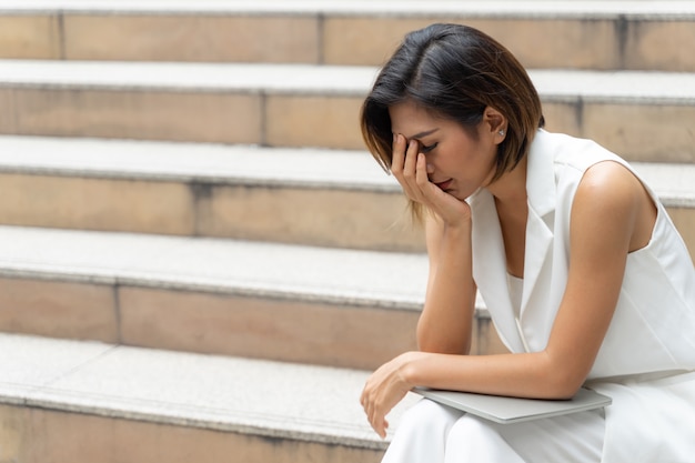 Sadness young woman crying on the stair Free Photo