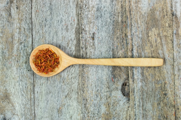 Premium Photo Safflower In Wood Spoon On Table