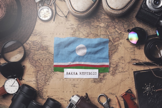 Premium Photo Sakha Republic Flag Between Traveler S Accessories On Old Vintage Map Overhead Shot