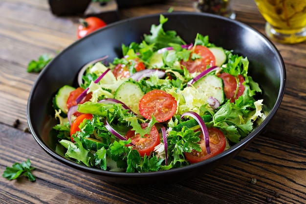 Free Photo | Salad from tomatoes, cucumber, red onions and lettuce ...