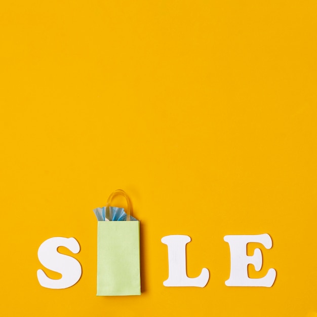 Free Photo | Sales with paper bags concept on orange background