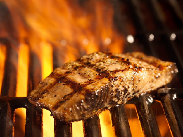 Premium Photo | Salmon Fillet On The Grill With Flames