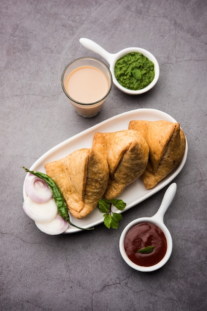 Premium Photo | Samosa - triangle shape fried / baked pastry with ...