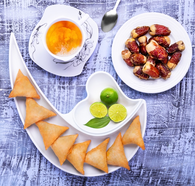 Premium Photo | Samosa with dates and tea