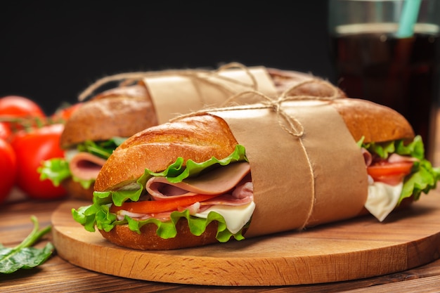 Sandwich on a wooden table | Premium Photo