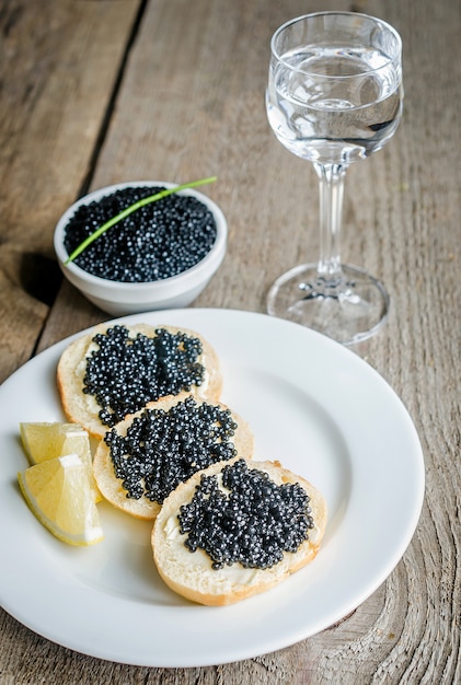 sandwiches-with-black-caviar-and-glass-o