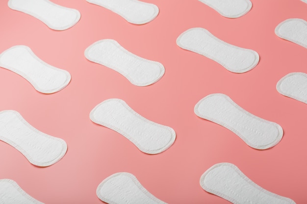 Premium Photo | Sanitary pad on a pink background in the form of a ...