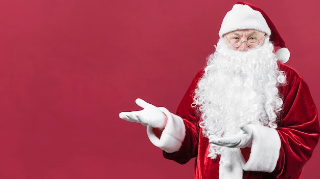 Santa claus showing something with hands Photo | Free Download