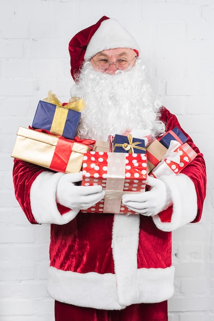 Free Photo | Santa claus with gifts in hands