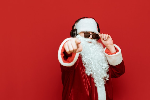 Premium Photo | Santa claus with headphones