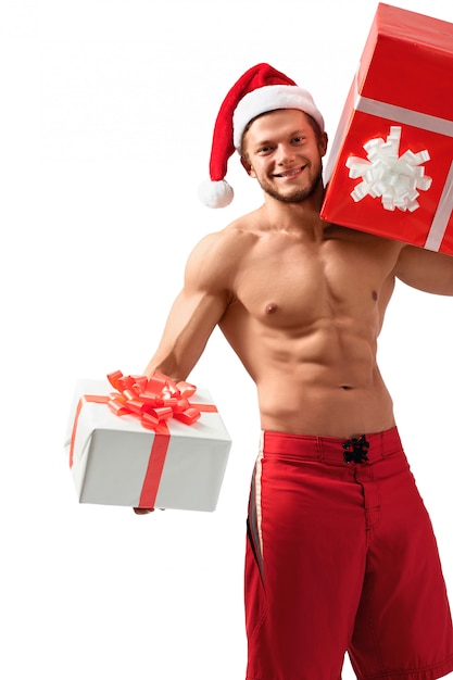 Premium Photo | Santa claus with two presents for xmas posing in studio.