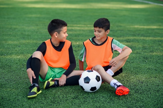 Premium Photo | Satisfied football player resting on sport field after ...