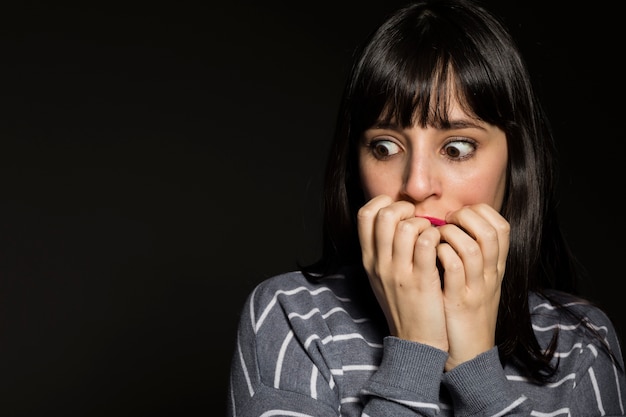 Scared woman covering mouth Free Photo
