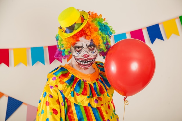 Premium Photo | Scary clown and red ball. violence and childhood fear