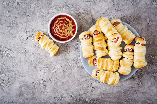 Premium Photo Scary Sausage Mummies In Dough With Funny Eyes On Table Halloween Food