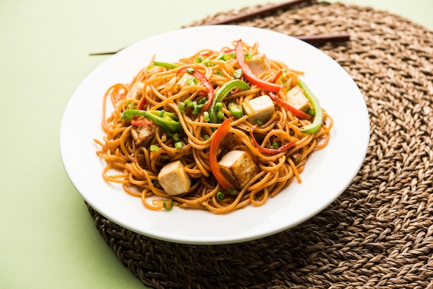 Premium Photo | Schezwan hakka noodles with paneer or cottage cheese ...