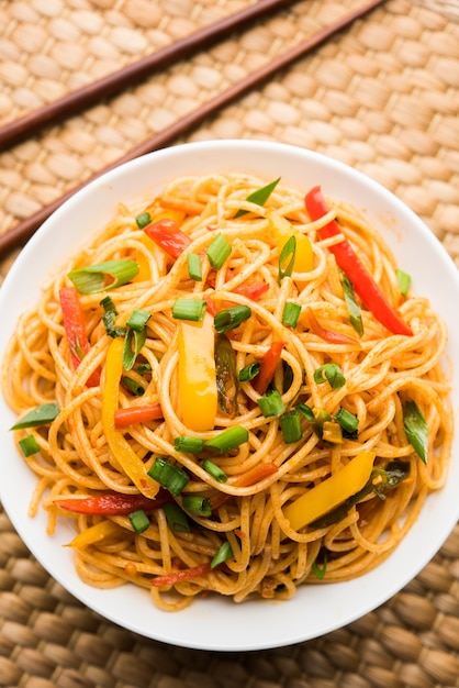 Premium Photo | Schezwan noodles or vegetable hakka noodles or chow ...
