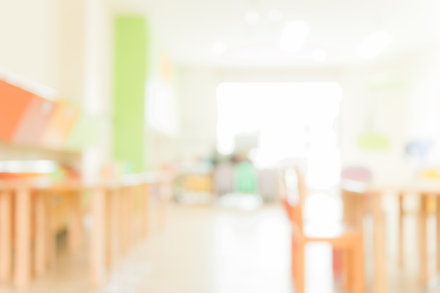 School classroom in blur background without young student; blurry view of elementary class room no kid or teacher with chairs and tables in campus. vintage effect style pictures. Free Photo