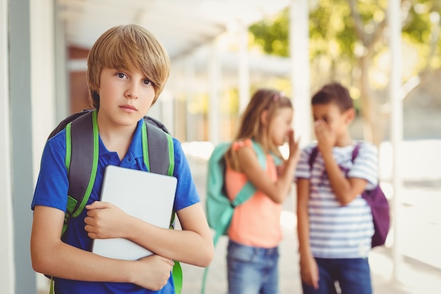 Premium Photo | School friends bullying a sad boy in corridor