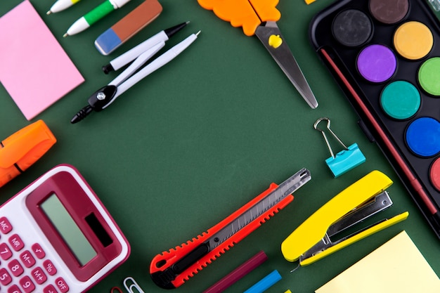 Premium Photo | School office supplies stationery on green