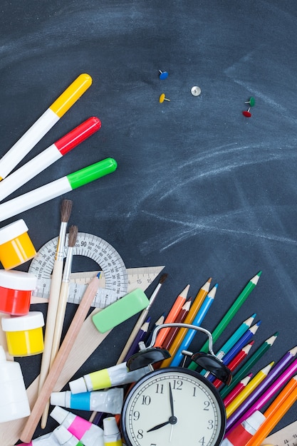 Premium Photo | School supplies on the background of the teachers' board