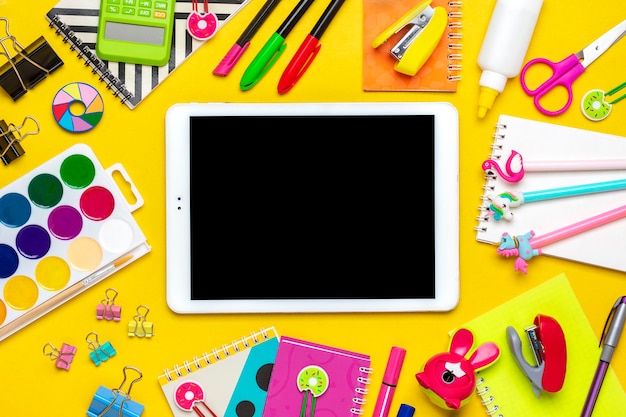 Premium Photo | School supplies isolated on yellow